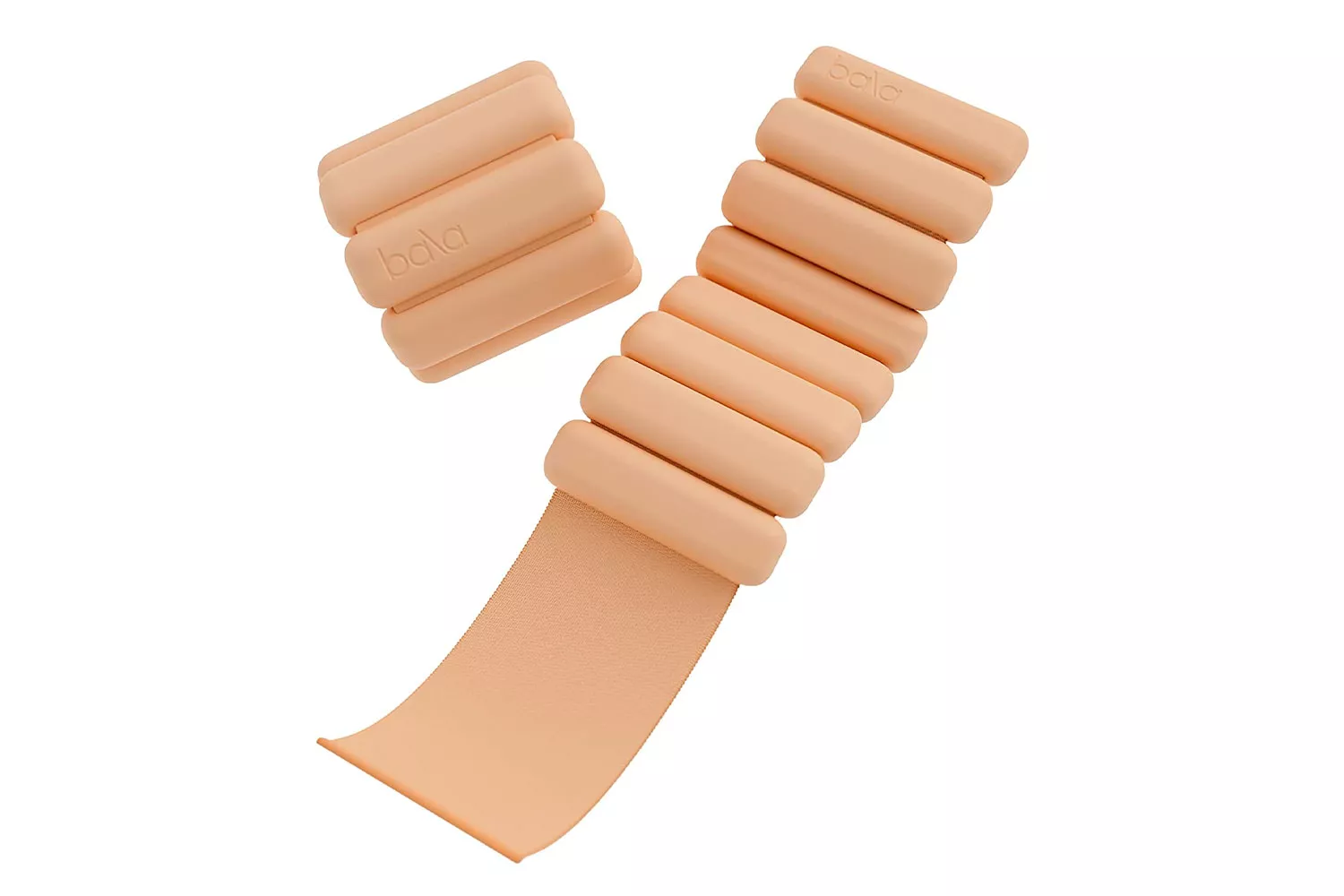 A pair of Bala Bangles being worn on ankles during a floor-based workout.