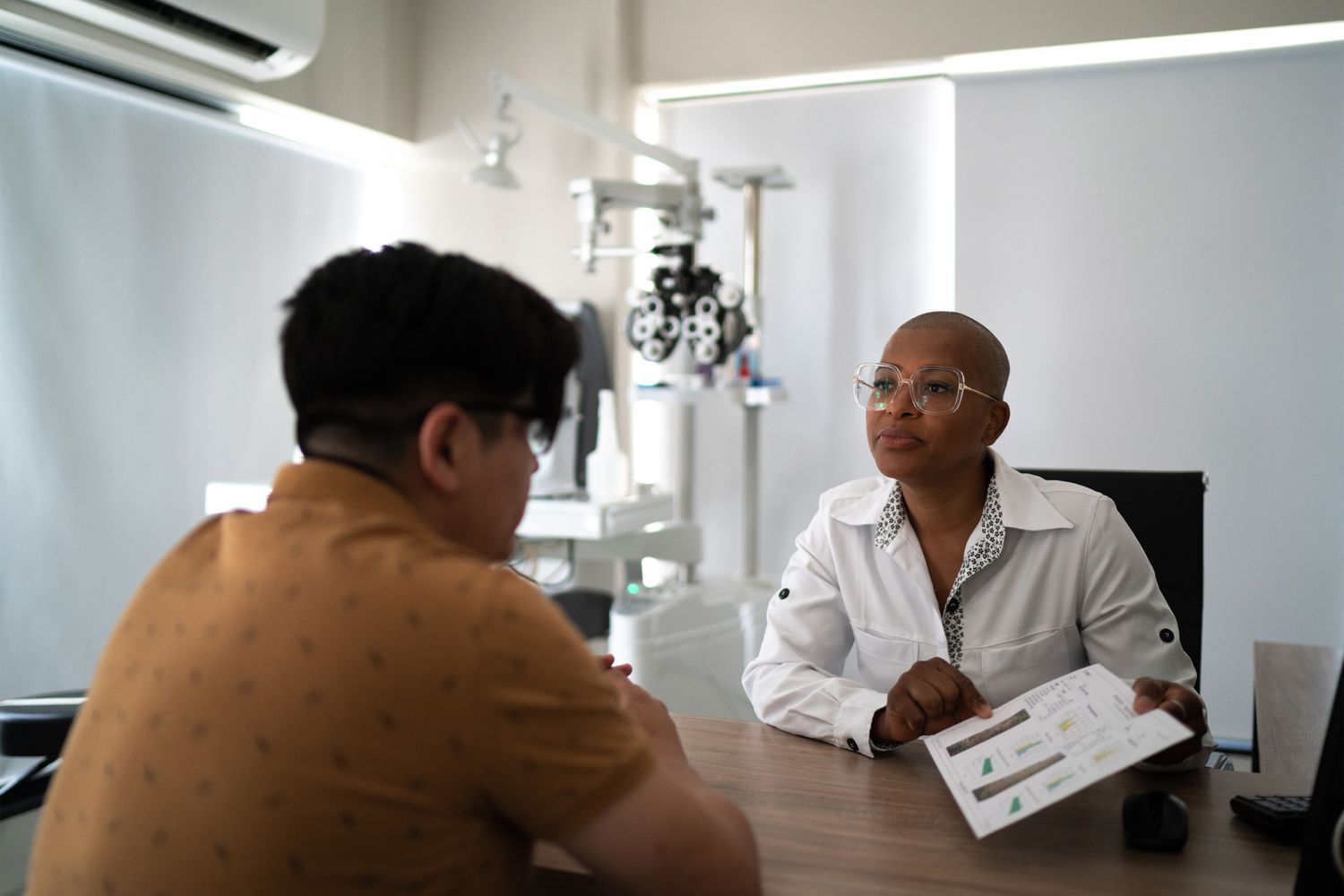 A patient having a professional consultation with a specialist regarding physical health symptoms.