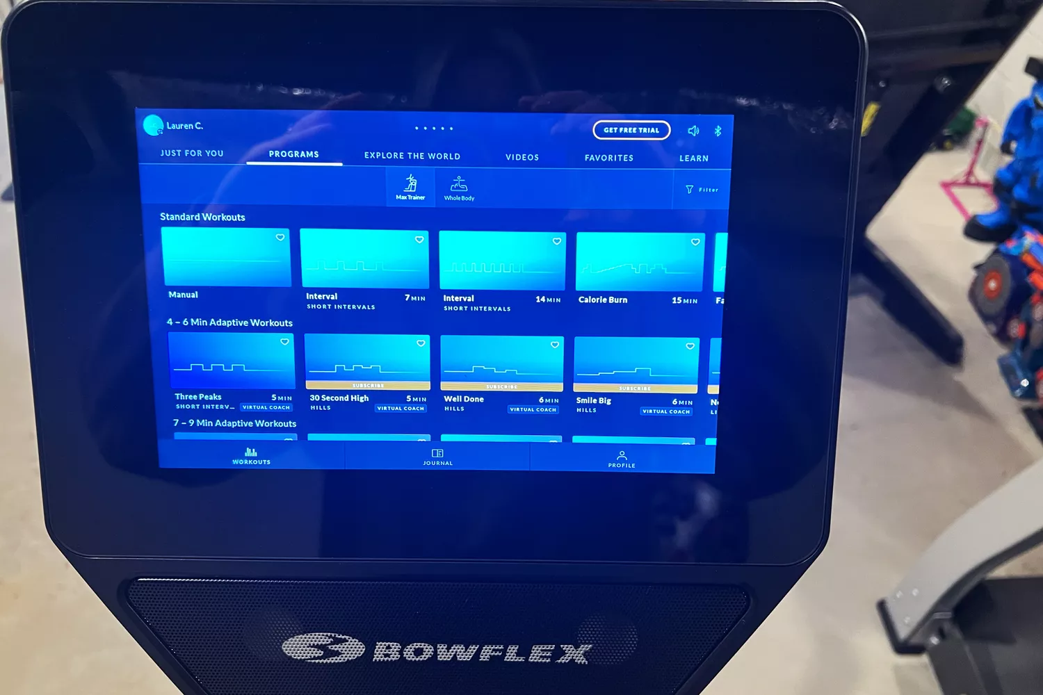 Close-up of the BowFlex Max Trainer M9 touchscreen showing workout program options like Manual and Interval.