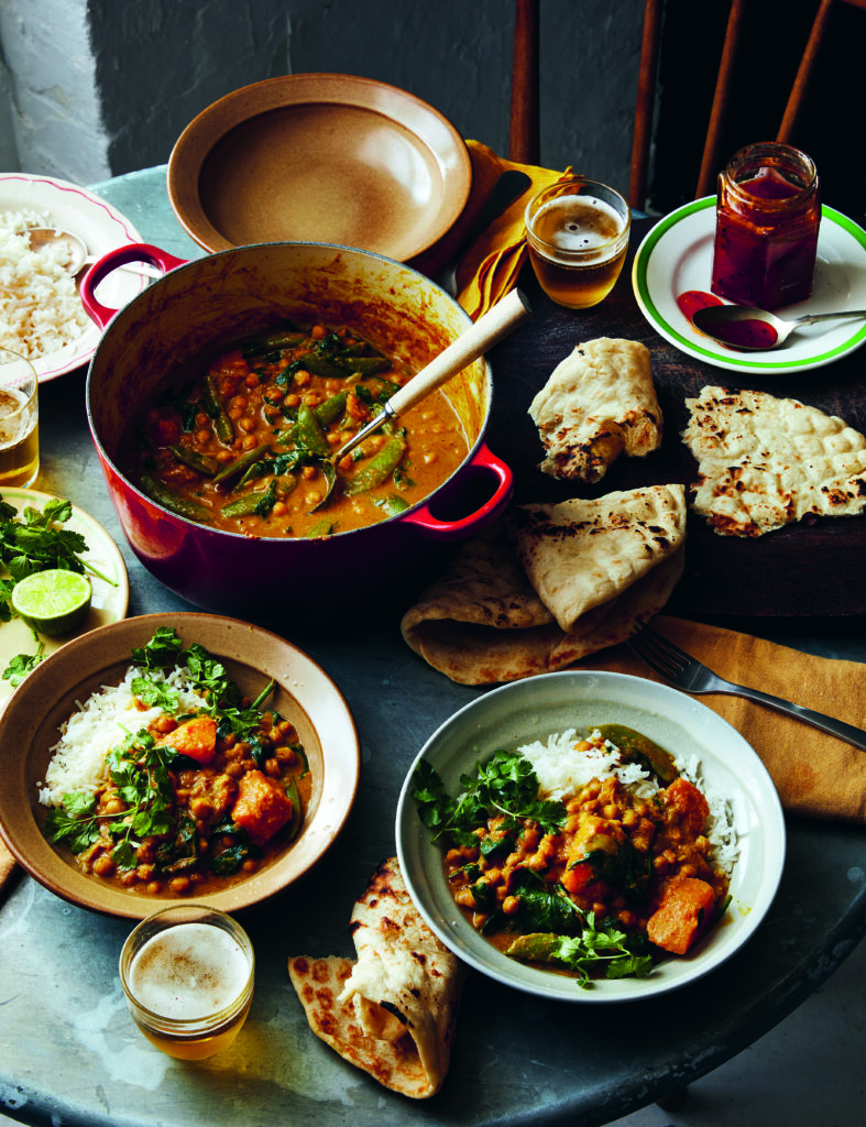 A bowl of slow-cooked beans with global seasonings, highlighting texture and depth of flavor.