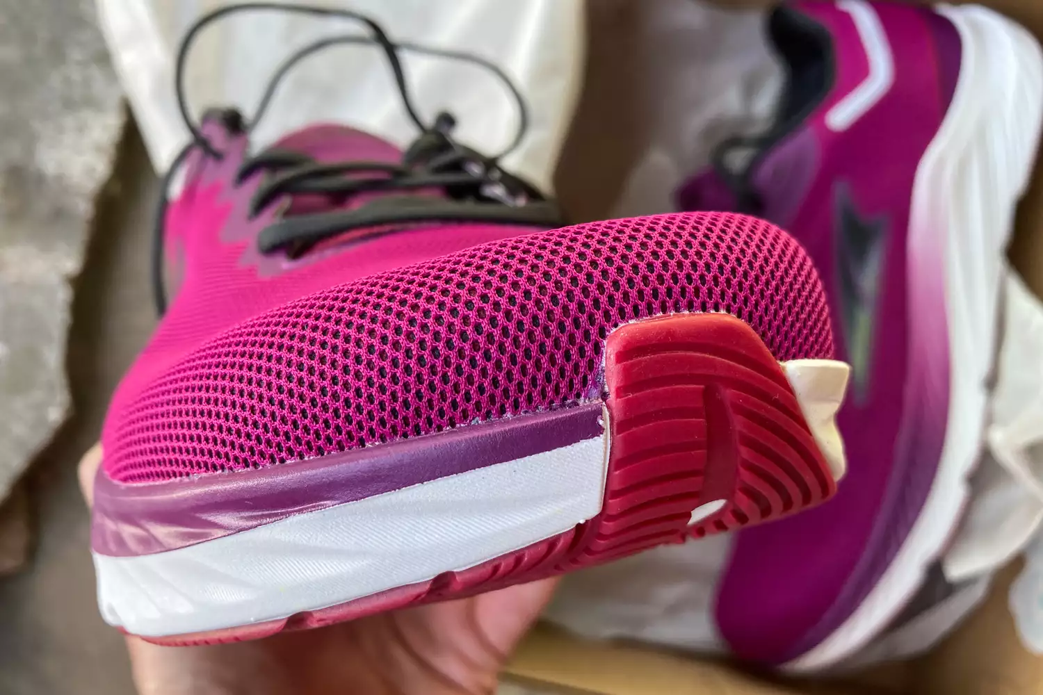 Close-up of a pink and purple Altra running shoe showing the wide, foot-shaped toe box and thick midsole.