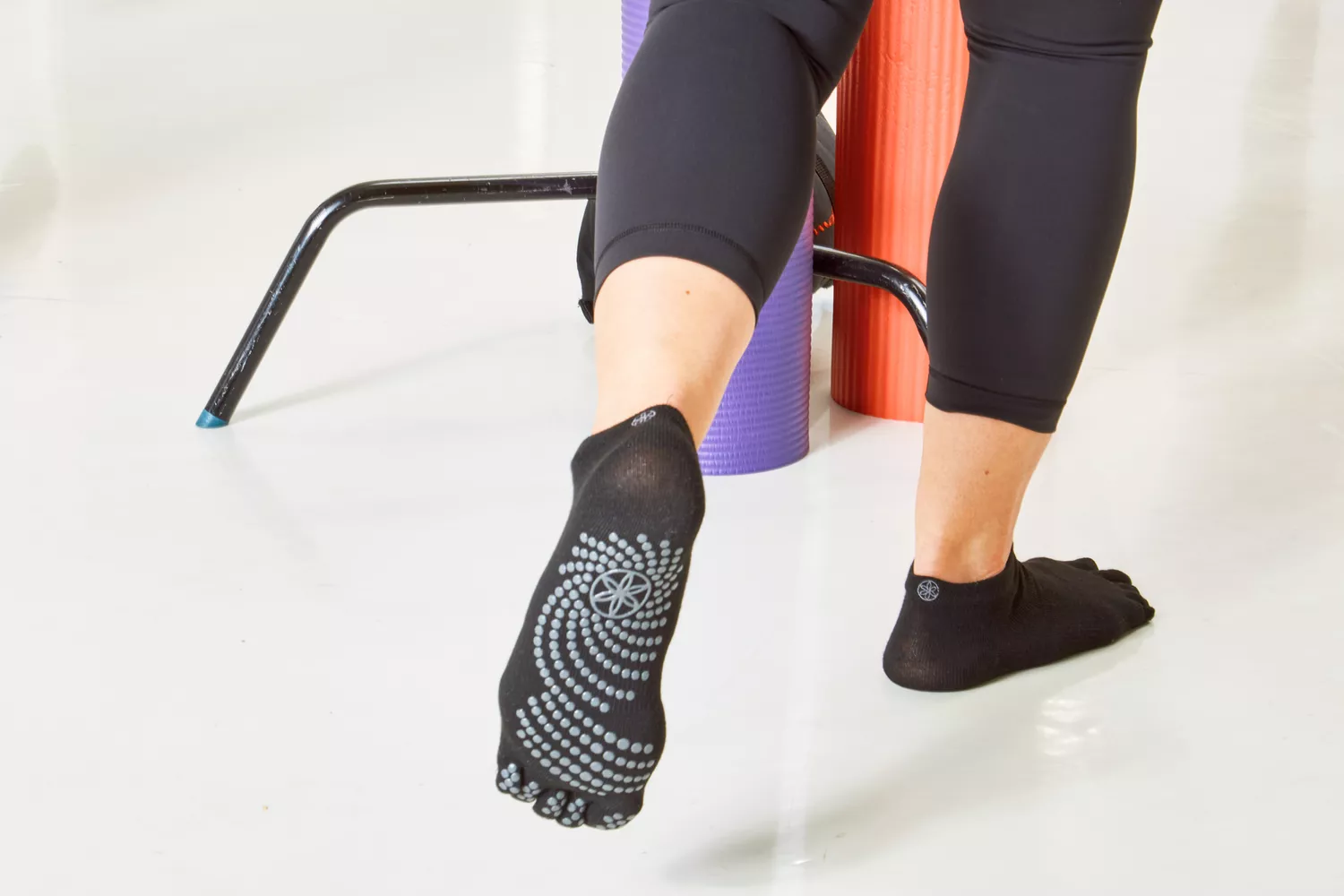 A close-up of feet wearing grippy yoga socks for better traction.