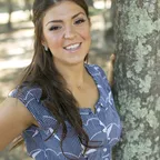 A woman smiling outdoors representing the energy benefits of maintaining energy levels on a 7-day keto strategy.