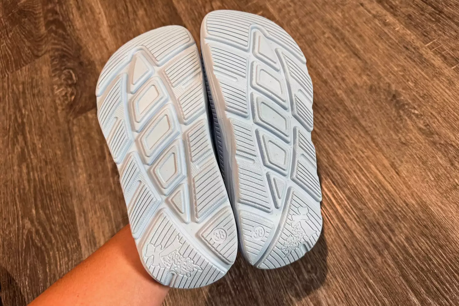 A close-up view of the white textured underside and tread patterns of ARISIC recovery slides.