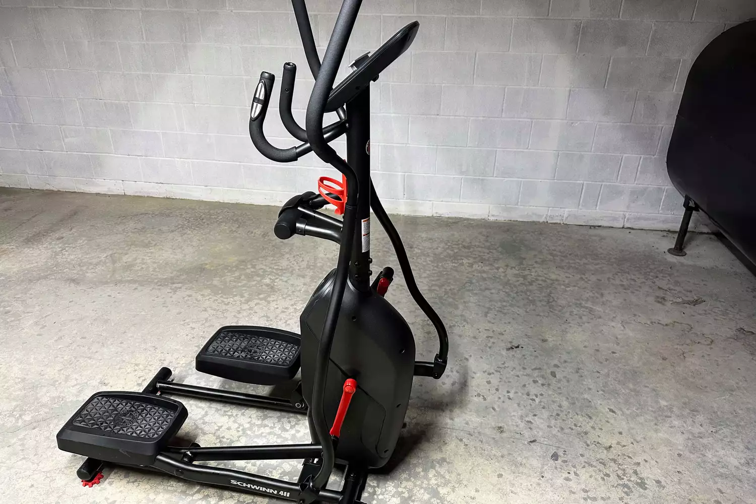 A side profile view of the Schwinn 411 Compact Elliptical Machine showing its shortened frame.