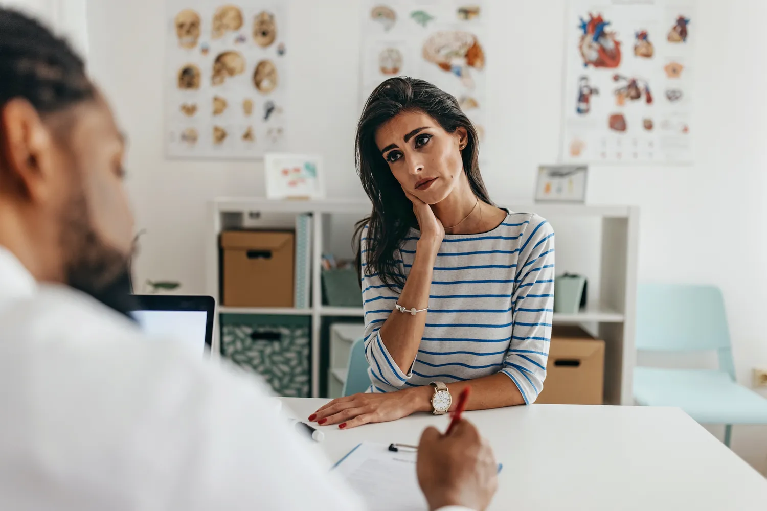 A patient in a consultation with a healthcare provider discussing chronic symptoms.