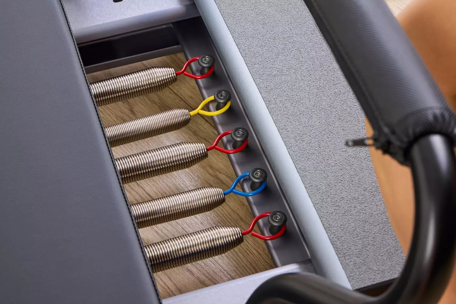 Close-up of the metal springs on a Balanced Body Allegro Reformer.