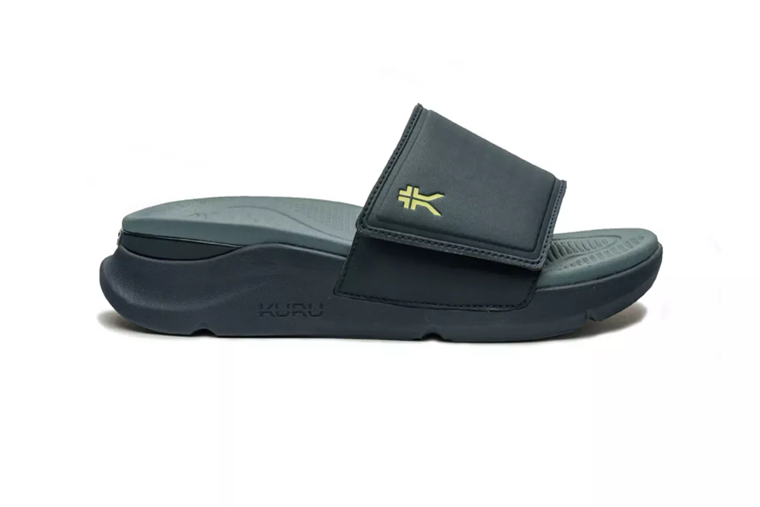 Side profile of a dark gray Kuru slide sandal showing the deep heel cup and contoured arch support.