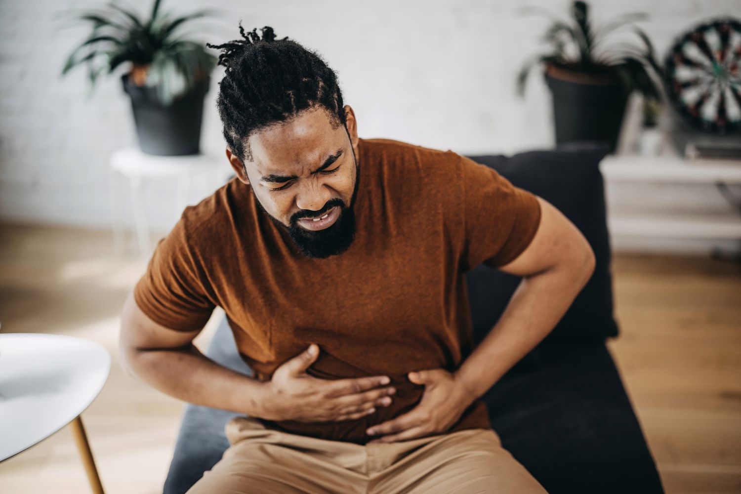 An individual appearing tired and experiencing a mild cough, symbolizing the early signs of infection.