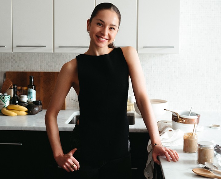 Jenelle Manzi demonstrating at-home wellness rituals focused on recovery and fascial health.