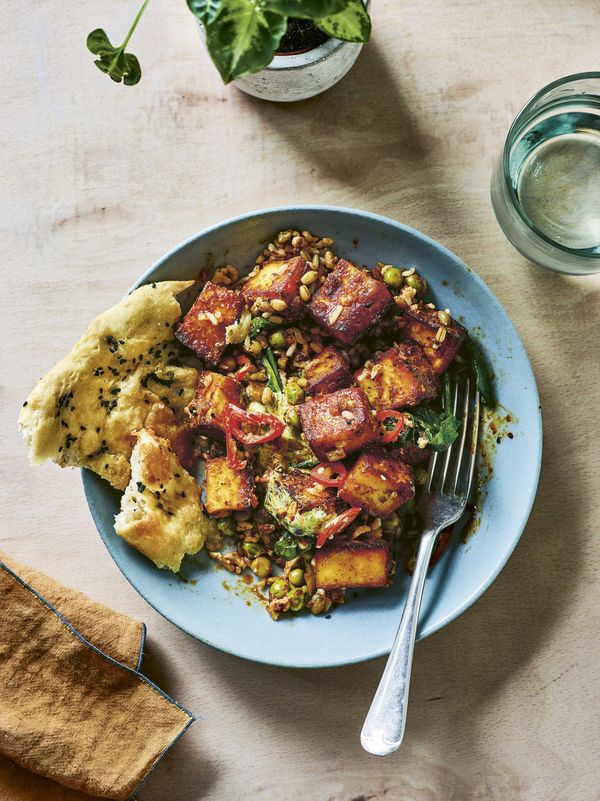 Close-up of fresh ingredients and prepped meal components in a bright kitchen setting.