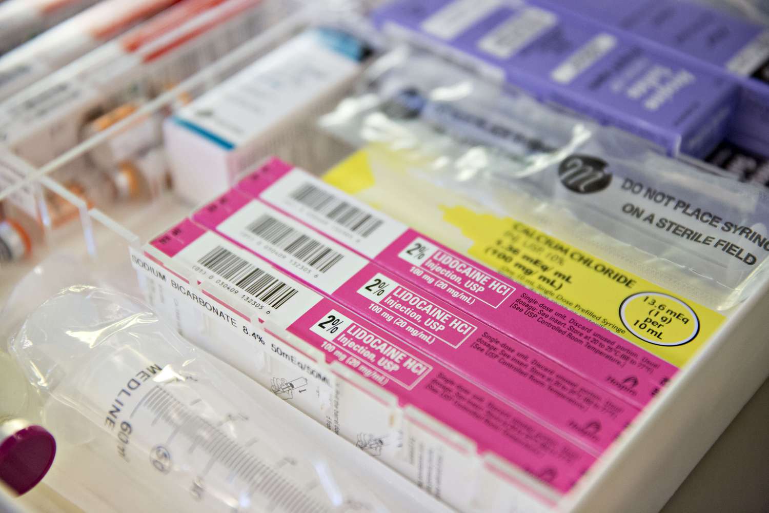 A lidocaine injection sits on a tray in a clinical setting.